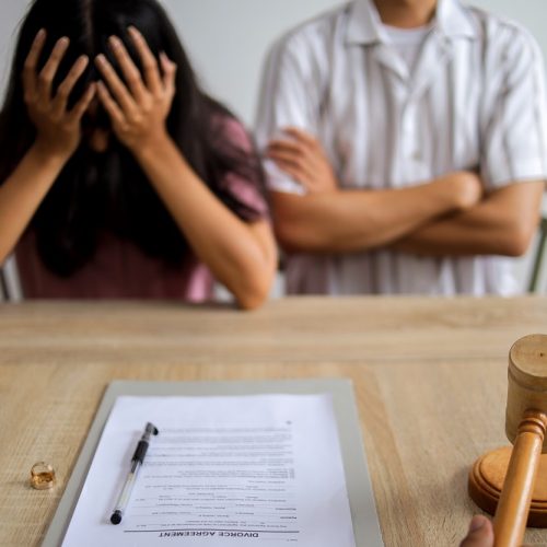 Unhappy Married Man and Woman Filing Divorce, Shares or Mortgage Assets with Attorney
